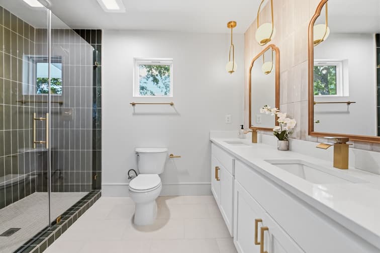 After - Primary bath view showing large walk-in shower and double vanity