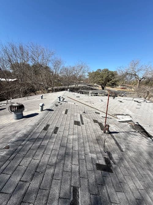 View of roof showing water stains and previous patchwork repairs